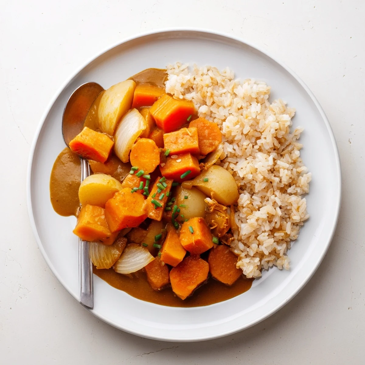 Roasted pumpkin glistens in savory Japanese curry sauce, creating a comforting dish.  
