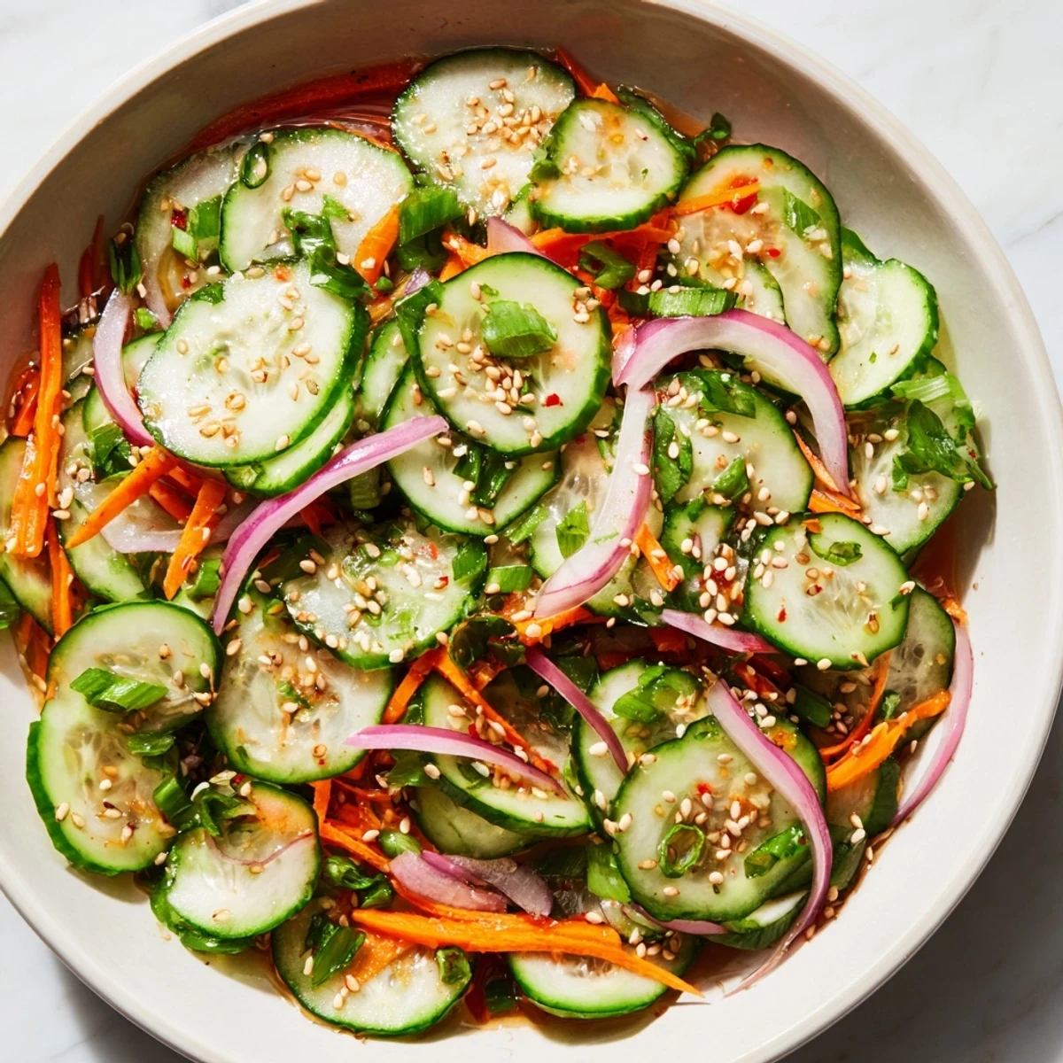 Cucumber Salad Remix featuring vibrant veggies, sesame oil, and a tangy dressing.  