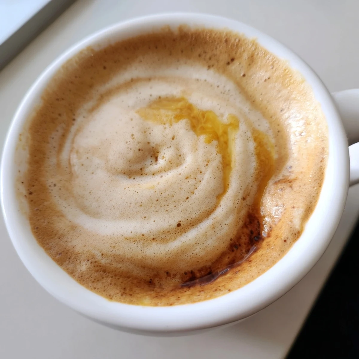 Creamy onion latte topped with frothed milk, offering a savory twist on coffee.  