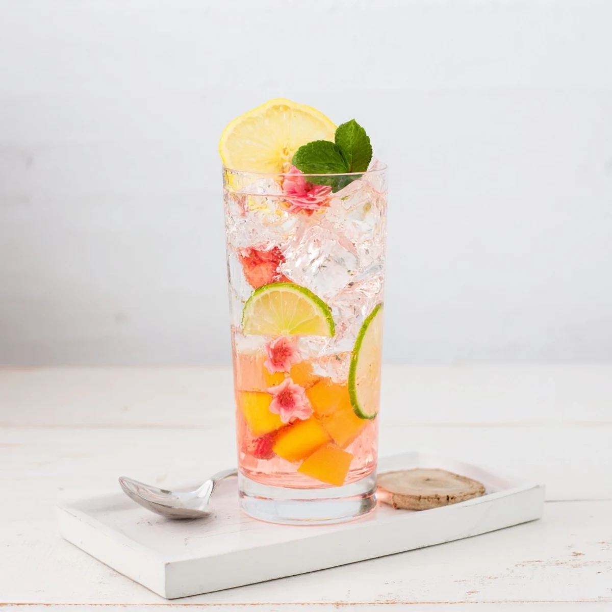 Hydrating mocktails blending flavored syrups with vibrant fruit slices and herbs for summer.  