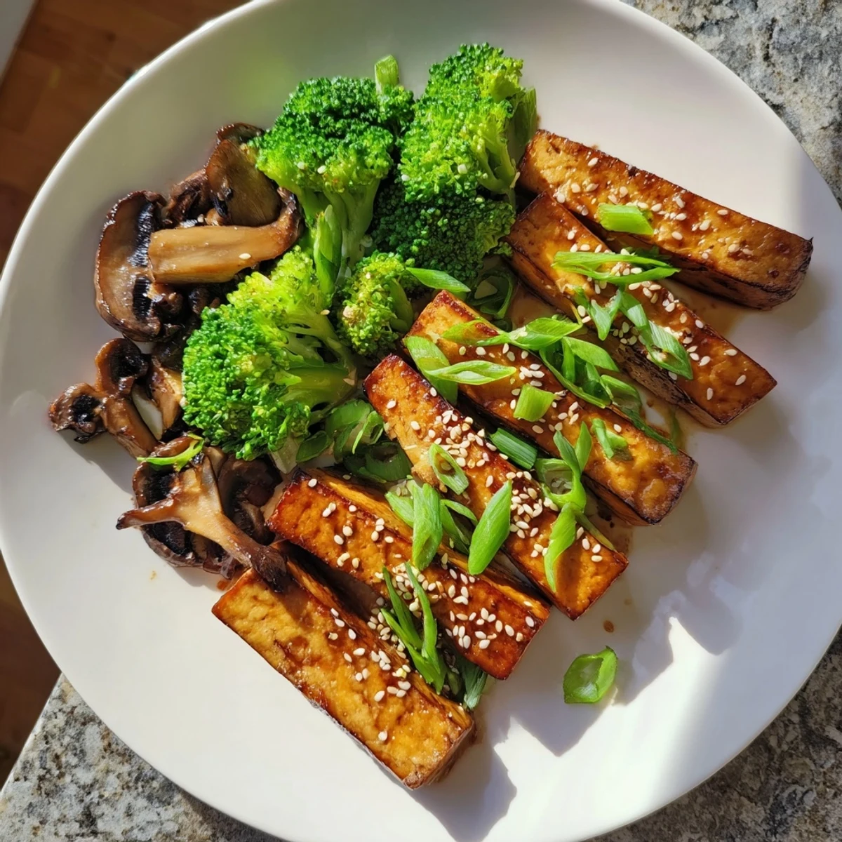 Sautéed Tofu Steak recipe showcases tender tofu, broccoli, and mushrooms—a hearty, plant-based meal.