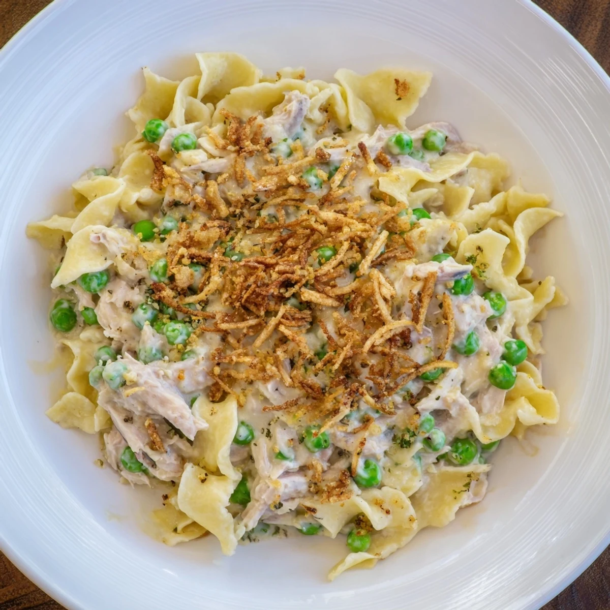 Golden, bubbly tuna noodle casserole with a crispy onion topping, perfect for an easy family dinner.