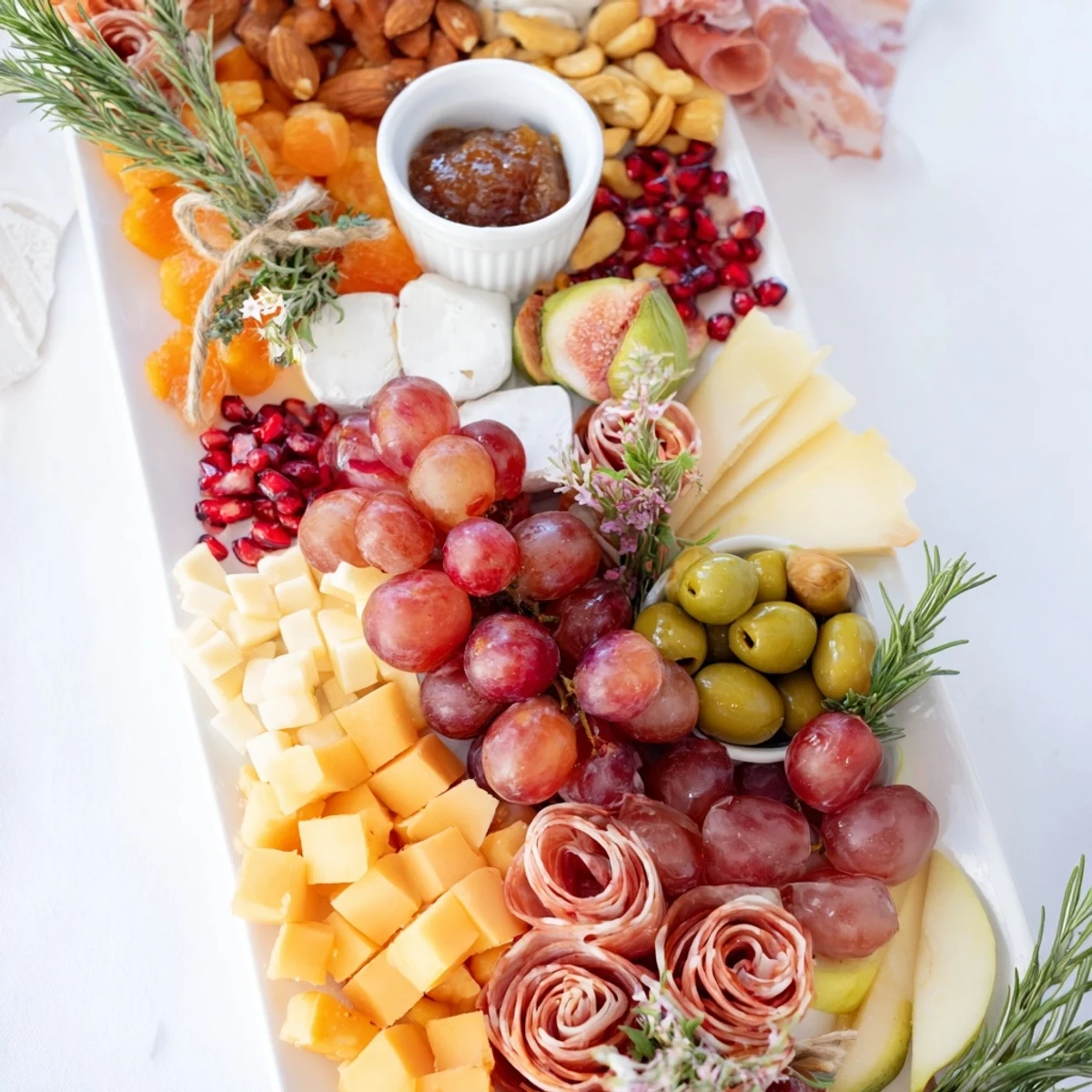 A beautifully arranged Holiday Bow Appetizer Platter, featuring vibrant fruits, nuts, and cheeses for festive entertaining.