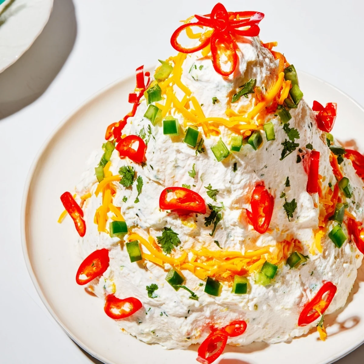 Creamy Chili Pepper Christmas Tree Dip shaped in a holiday tree, ready to be served with crackers.