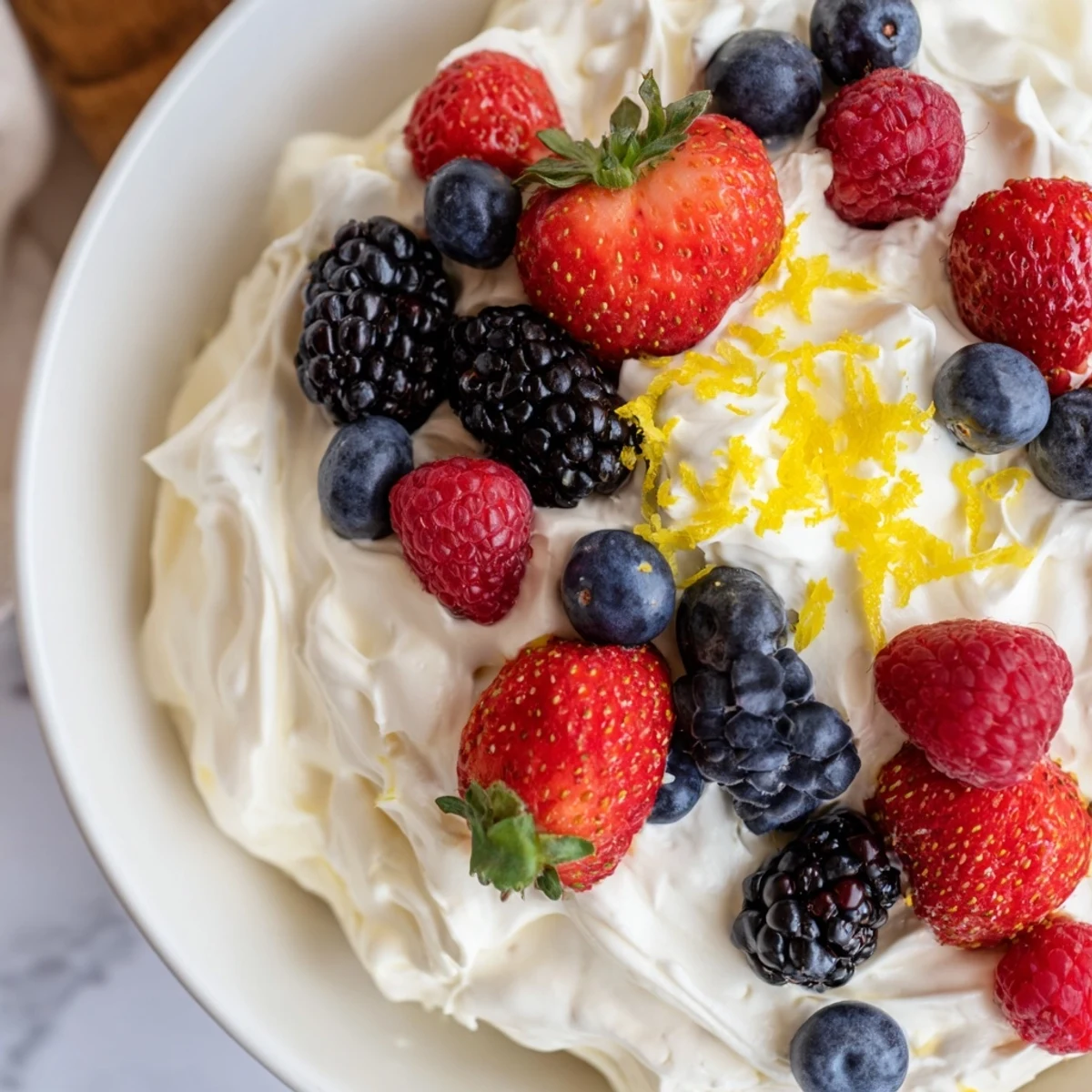 Fluffy Cream Cheese Fruit Dip, a creamy cloud of sweetness, surrounded by vibrant berries.