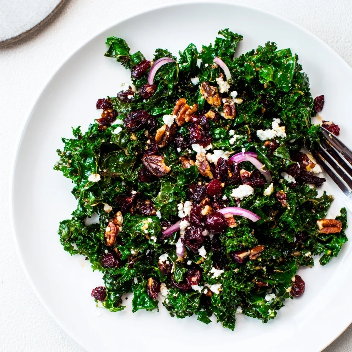 Tender massaged kale with warm maple mustard dressing, topped with toasted pecans, dried cranberries, and crumbled feta.