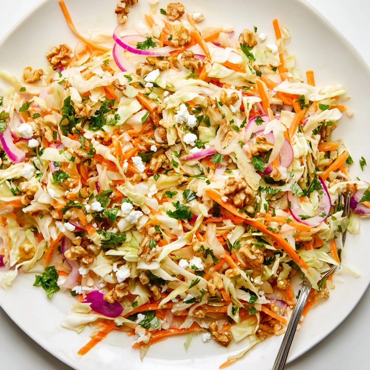 This vibrant Cooked and Loved Cabbage Salad features tender sautéed cabbage, crisp veggies, and a Dijon-herb vinaigrette, finished with walnuts for crunch.  