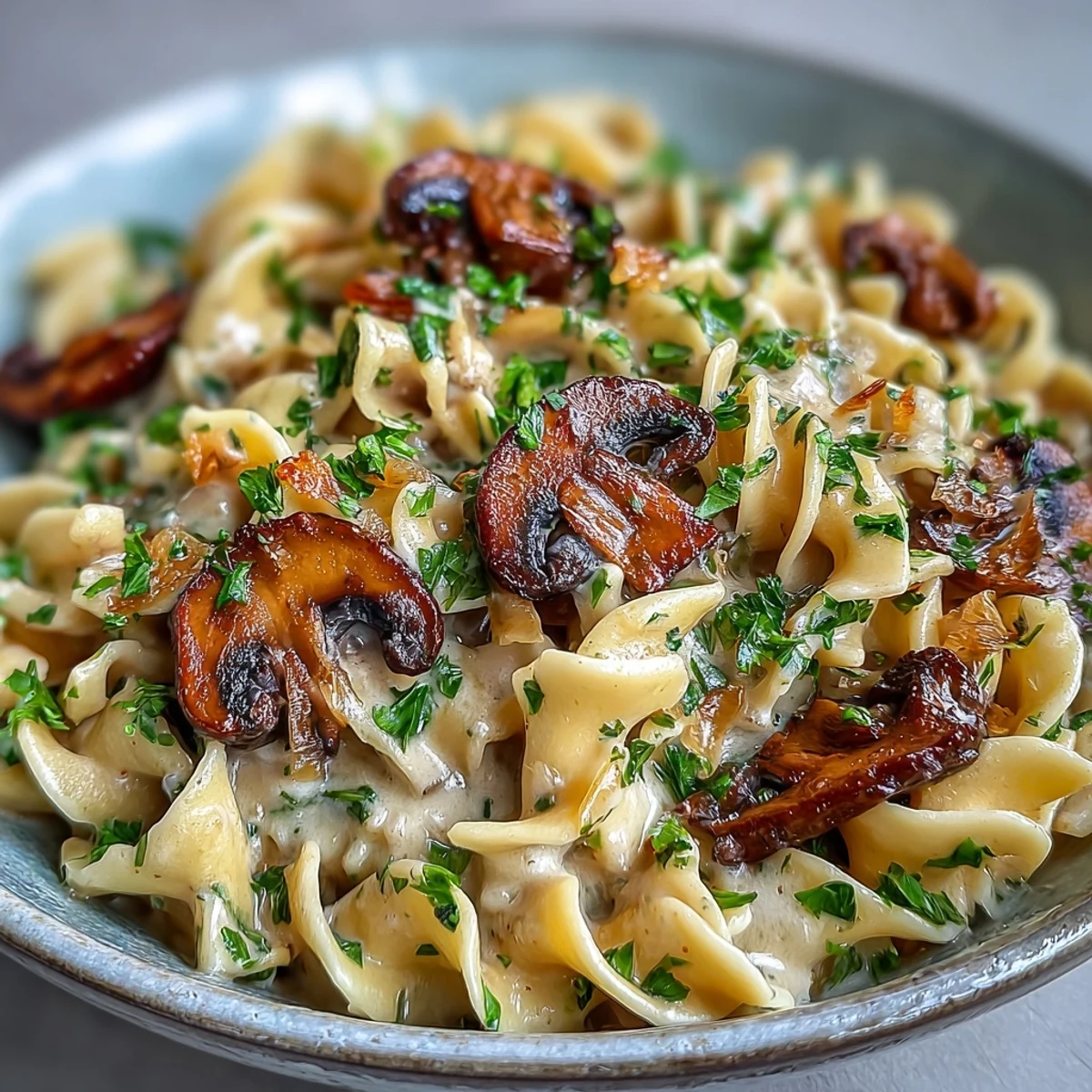 Creamy Mushroom Stroganoff with sautéed mushrooms and herbs, tossed in a silky sauce over wide fettuccine noodles.