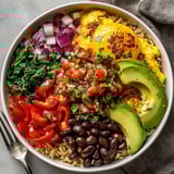 A close-up of a Breakfast Burrito Bowl showcasing fresh cilantro and creamy avocado slices.