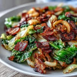 Tender sautéed cabbage, crispy bacon, caramelized onions, a perfect side dish.
