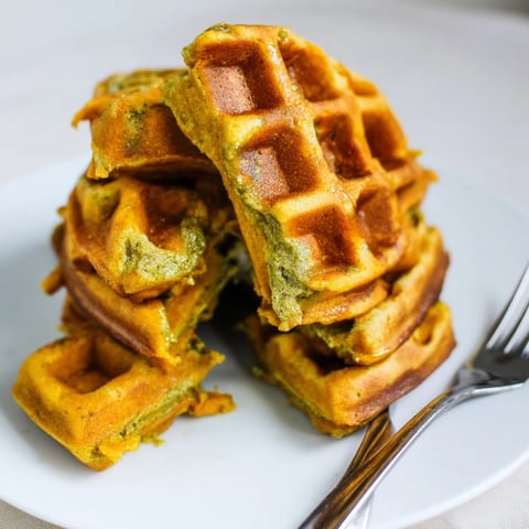 Fluffy matcha pumpkin muffin waffles topped with maple syrup for a cozy brunch.  