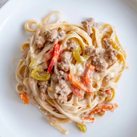 Creamy Pepper Ground Beef Fettuccine topped with colorful bell peppers and savory beef.  