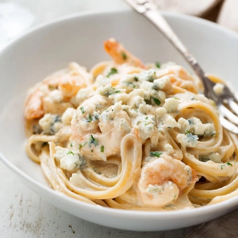 Creamy Blue Cheese Shrimp Pasta with linguine, garnished with parsley and walnuts.  