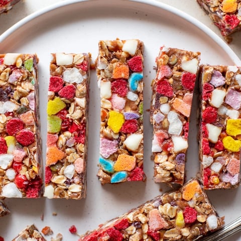 Chewy DIY snack bars topped with bright homemade gummies and freeze-dried candies.