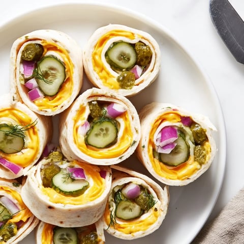 Crispy Pickle-in-a-Blanket snacks wrapped in creamy cheese and soft tortillas.  