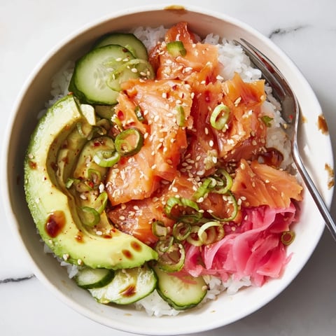 Leftover Salmon & Rice Bowl topped with fresh avocado and cucumber slices.  