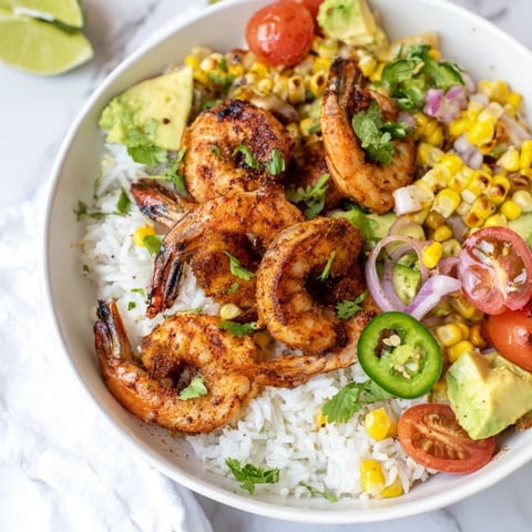 Juicy grilled shrimp bowl topped with creamy avocado and sweet corn salsa.  