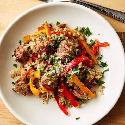 Sizzling Italian Sausage & Peppers Rice Plate, a vibrant mix of colorful peppers, savory sausage, and fluffy rice.