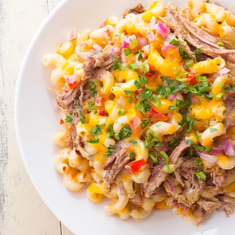 Golden-brown BBQ Rib Macaroni Skillet, bubbling with melted cheeses and rich barbecue flavors.