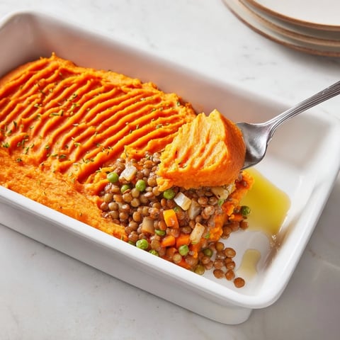 Golden-topped Veggie Shepherd's Pie features a creamy sweet potato mash, perfect for a cozy dinner.