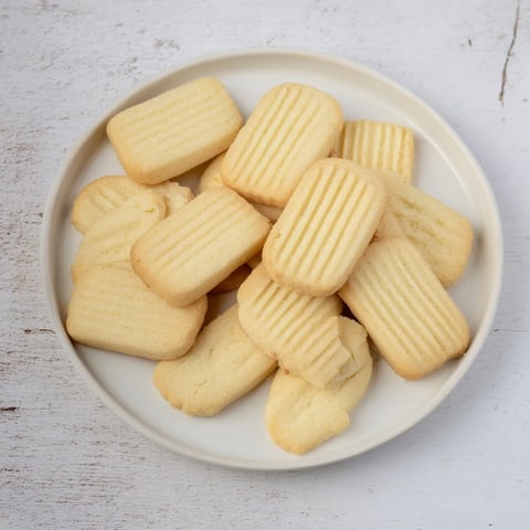 Golden-edged classic shortbread cookies, perfect for tea, with a crumbly, buttery texture, ready to enjoy.
