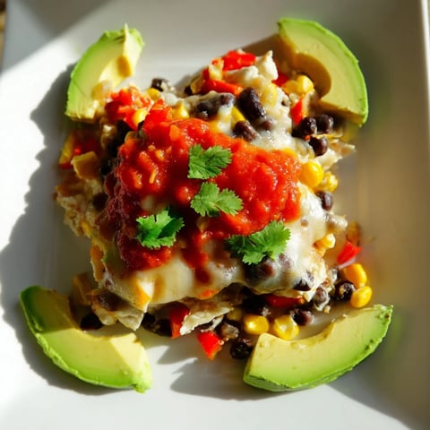 Quick Black Bean and Corn Tortilla Casserole bubbling with melted cheese, a flavorful Mexican-inspired delight.
