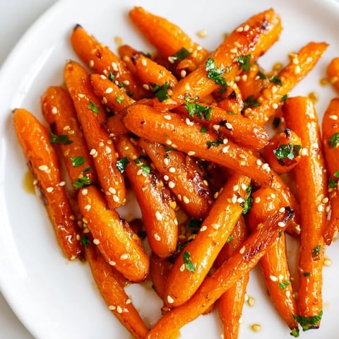 Honey soy roasted carrots glistening with a sweet, savory glaze, ready to serve as a bright side.