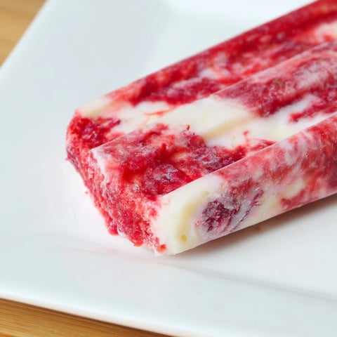 Vibrant Raspberry Coconut Ice Pops, layered and refreshing, offer a cool, fruity summer dessert experience for everyone.