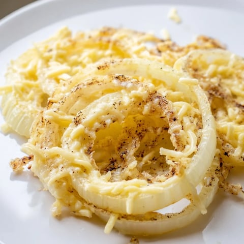 Golden, bubbly Crispy Onion Cheese Chips, a savory snack with melted cheese and crispy onions.
