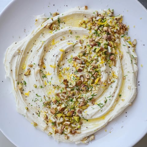 Vibrant butter board charcuterie with toasted nuts, fresh herbs, and bright lemon zest, ready to serve.