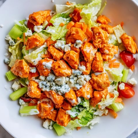 Crisp romaine and spicy buffalo chicken tossed with celery, carrots, and tangy blue cheese crumbles for a hearty chopped salad. 