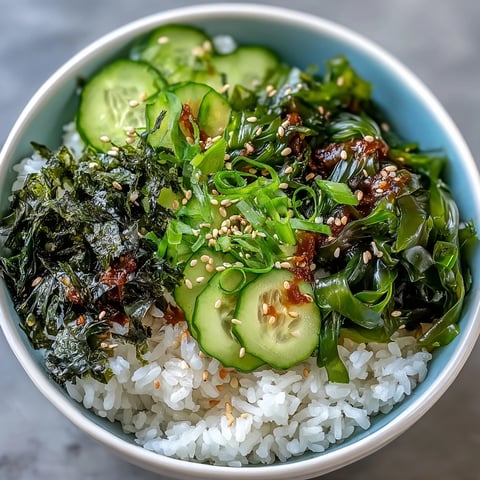 A vibrant seaweed and nori rice bowl with seasoned sushi rice, crisp cucumber, and toasted sesame seeds for a nourishing meal.