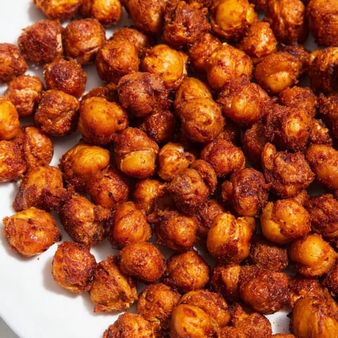 Homemade garlic BBQ roasted chickpeas filling a bowl, smoky and seasoned perfectly.