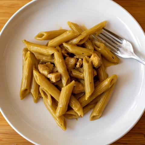 Savory honey mustard chicken pasta twirled with penne, exuding mouthwatering aroma.  
