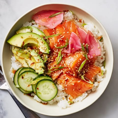 Warm, flavorful Leftover Salmon & Rice Bowl drizzled with soy sauce and sesame oil.  