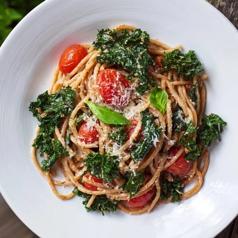 A close-up of the delicious one-pot spaghetti, showing tender pasta, vibrant kale, and ripe tomatoes.