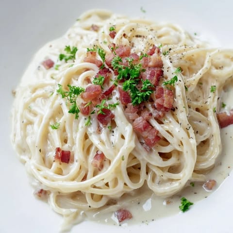 A close-up of quick Ramen Carbonara Hack, featuring perfectly coated noodles and fresh parsley garnish.