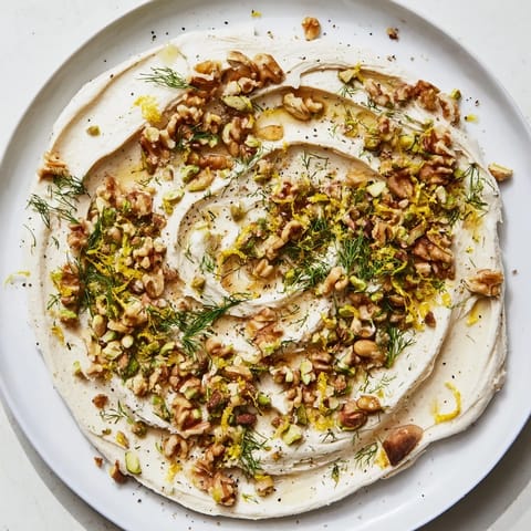 A creamy butter board charcuterie appetizer with flaky salt and golden toasted nuts, perfect for sharing.