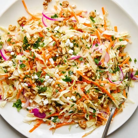 This vibrant Cooked and Loved Cabbage Salad features tender sautéed cabbage, crisp veggies, and a Dijon-herb vinaigrette, finished with walnuts for crunch.  