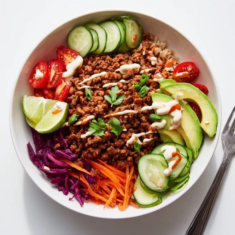 Satisfying plant-based meat bowl garnished with avocado, cilantro, and vibrant veggies.