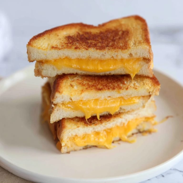 Crispy, golden Air Fryer Grilled Cheese sandwich ready to enjoy with a classic American side.
