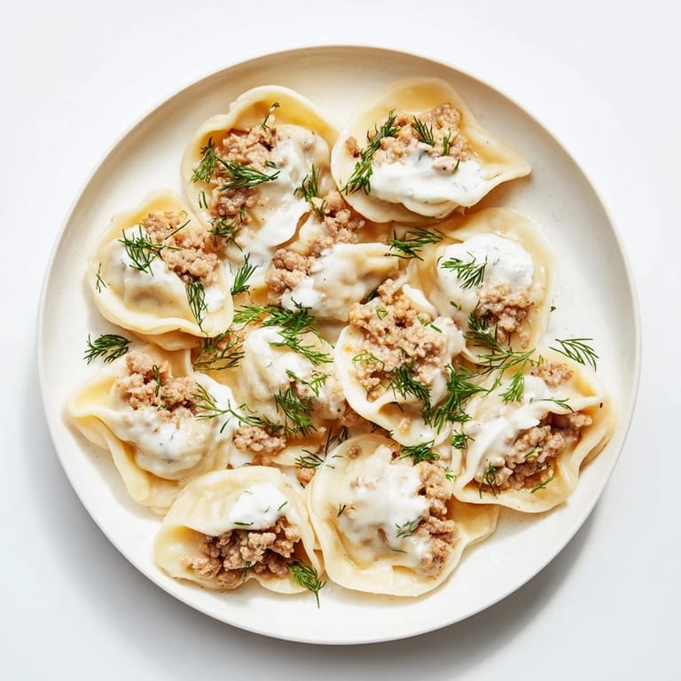 Savory, homemade Russian Pelmeni, with a tender dough and flavorful meat filling, beautifully presented.