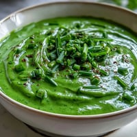 A vibrant green Spinach and White Bean Shamrock Soup with tender vegetables and creamy white beans.