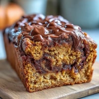 Moist Pumpkin Chocolate Swirl Banana Bread baked golden with gooey chocolate ribbons.